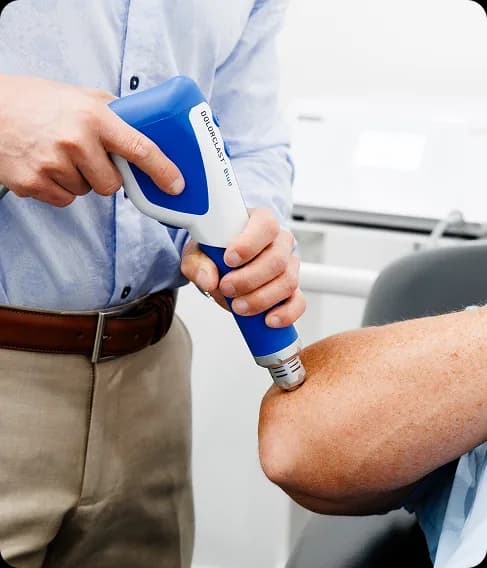 Focused shockwave treatment being applied to a patient's elbow for tennis elbow